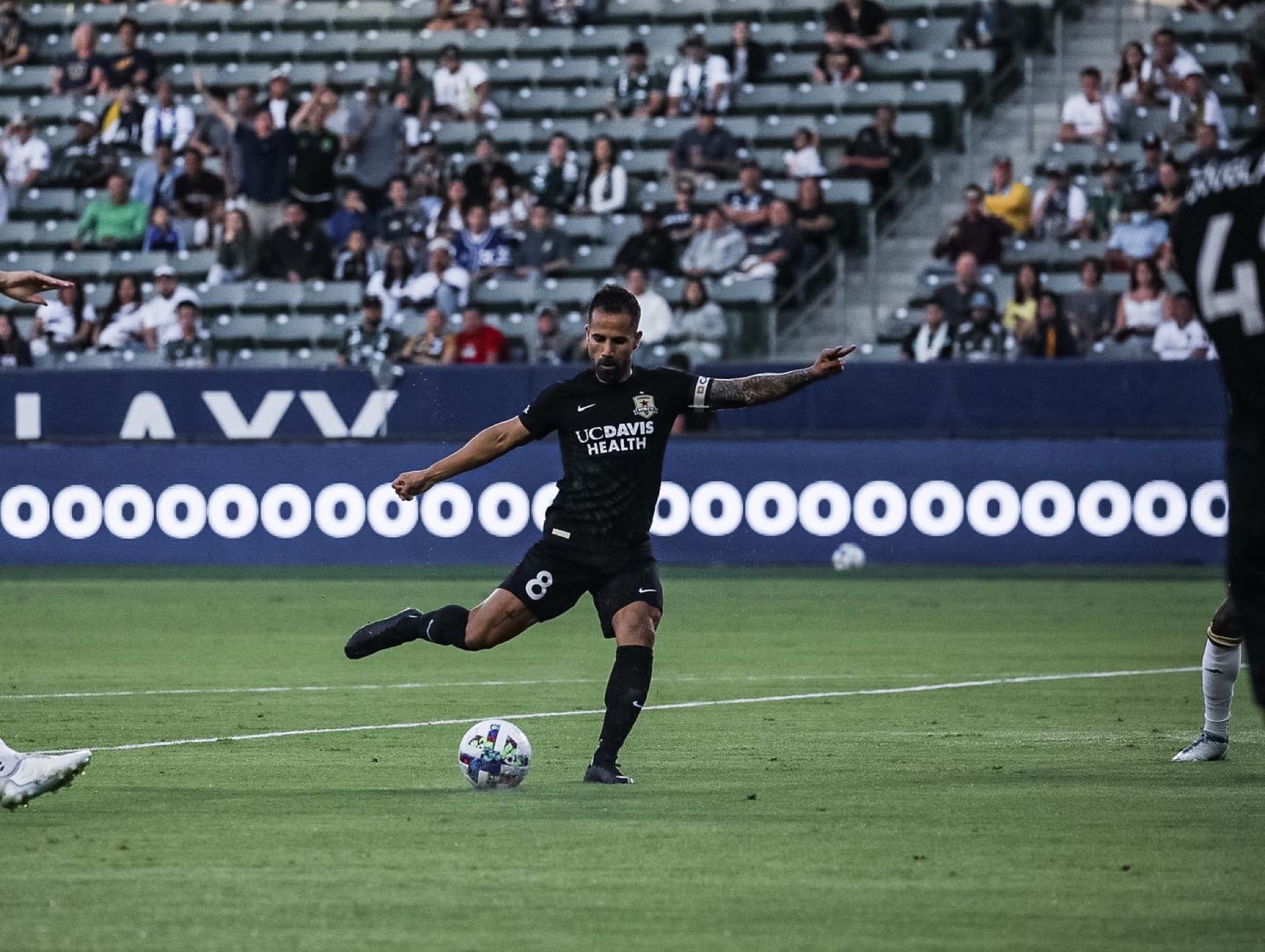 Roro López striking the ball under stadium floodlights